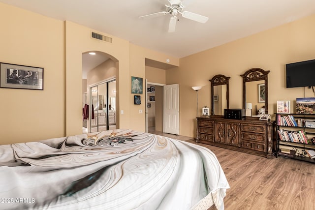 bedroom featuring ceiling fan, a closet, and light hardwood / wood-style flooring