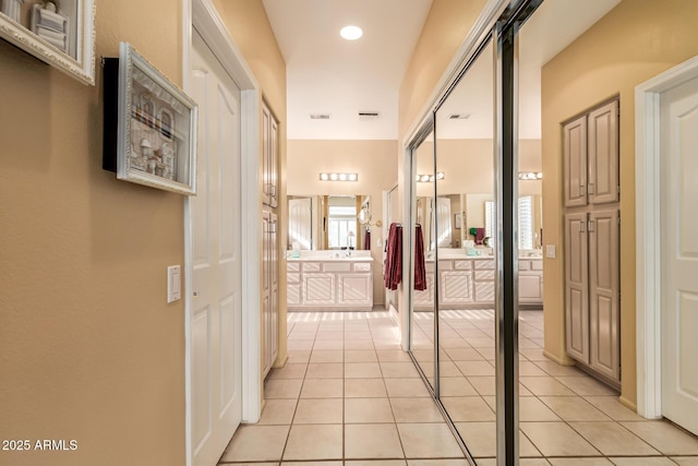 hall featuring light tile patterned floors