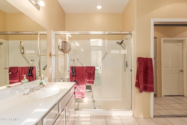 bathroom featuring tile patterned flooring, vanity, and walk in shower