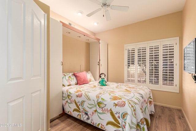 bedroom with hardwood / wood-style floors and ceiling fan