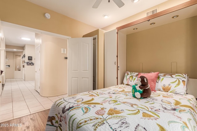 bedroom with ceiling fan and light wood-type flooring