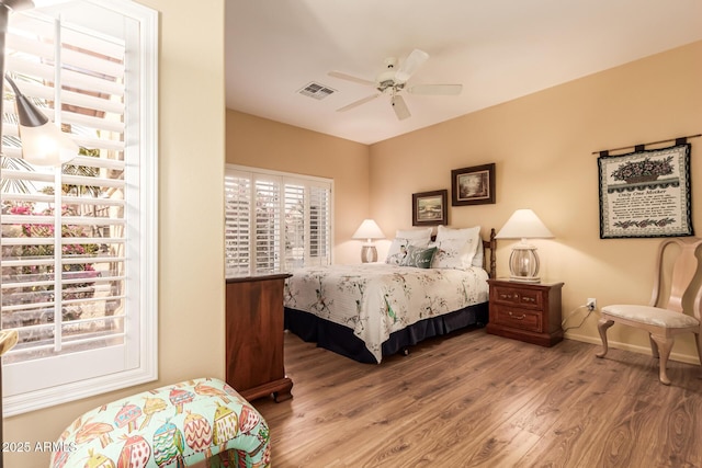 bedroom with hardwood / wood-style floors and ceiling fan