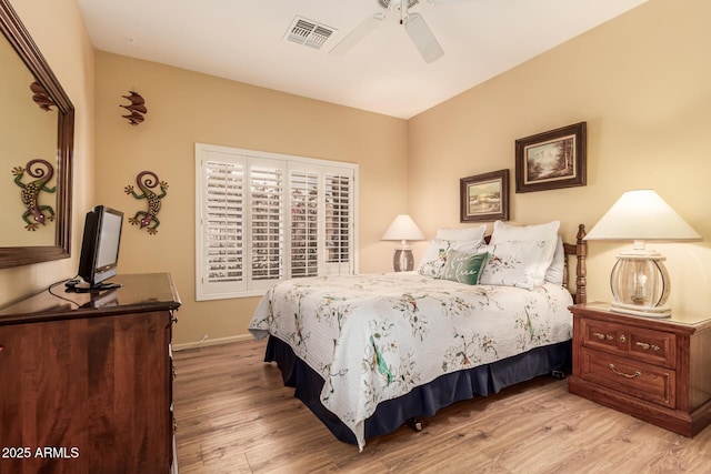 bedroom with ceiling fan and light hardwood / wood-style floors