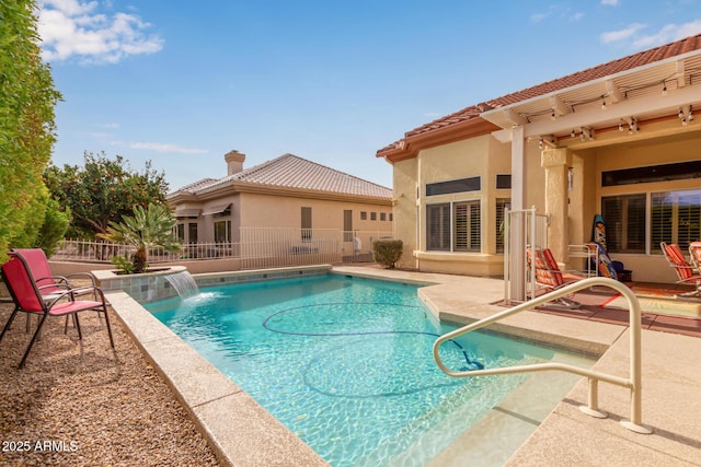 view of pool with a patio area and pool water feature