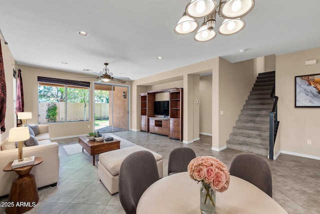 living room featuring baseboards, ceiling fan with notable chandelier, stairway, and recessed lighting