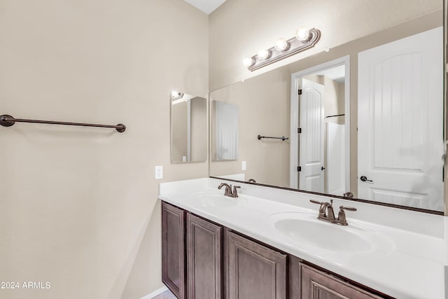 full bath featuring double vanity and a sink