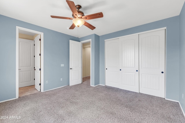 unfurnished bedroom featuring a ceiling fan, a closet, carpet flooring, and baseboards