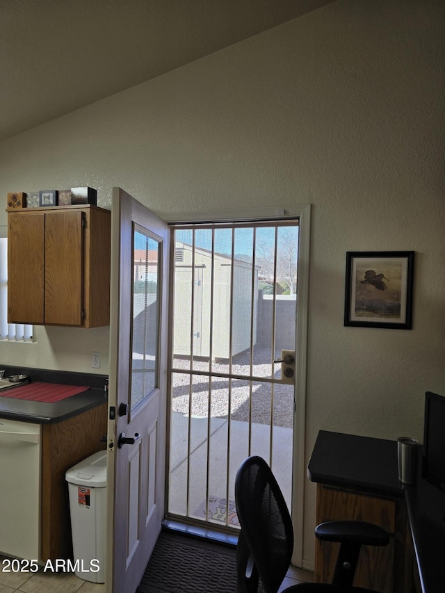 interior space featuring lofted ceiling and a textured wall