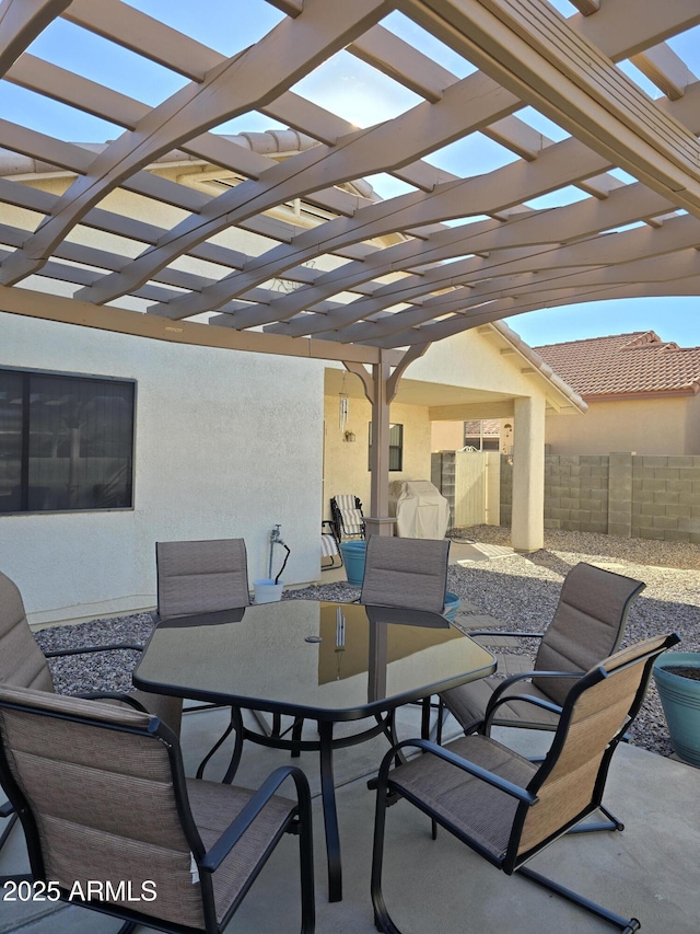 view of patio / terrace featuring outdoor dining space, fence, and a pergola