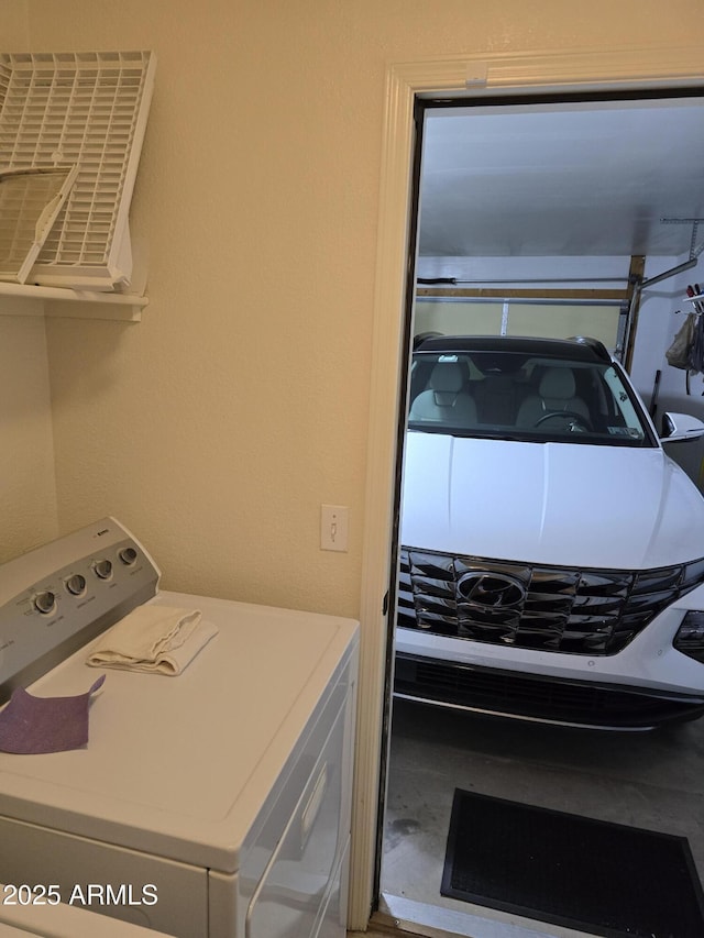 clothes washing area featuring laundry area and washer / dryer