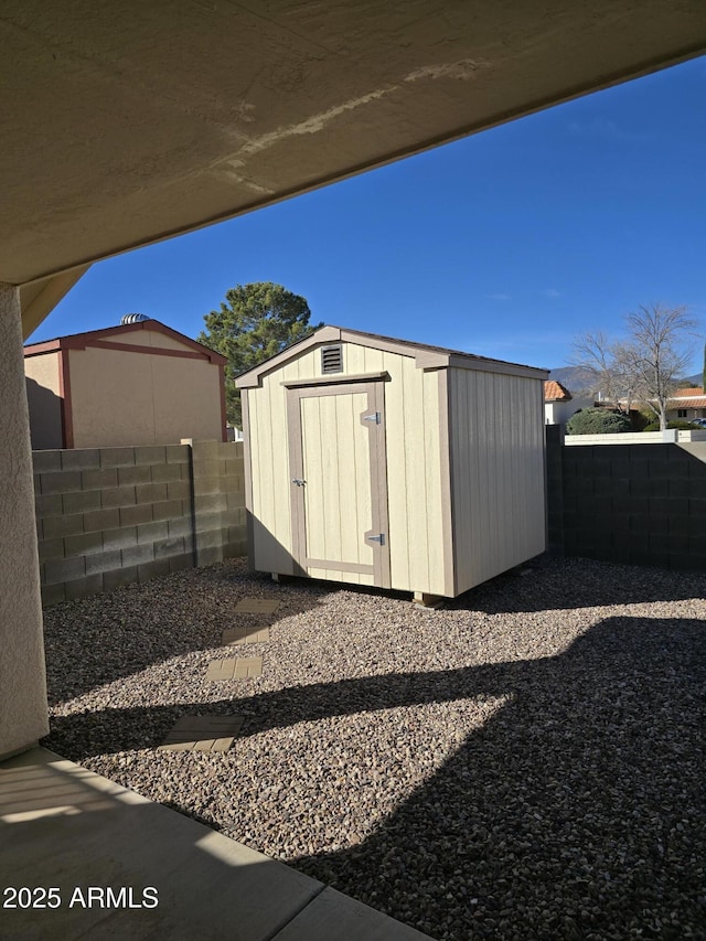 view of shed with a fenced backyard