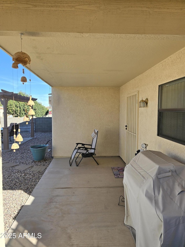 view of patio featuring fence