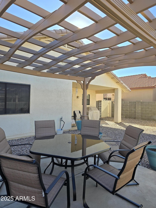 view of patio with fence, a pergola, and outdoor dining area