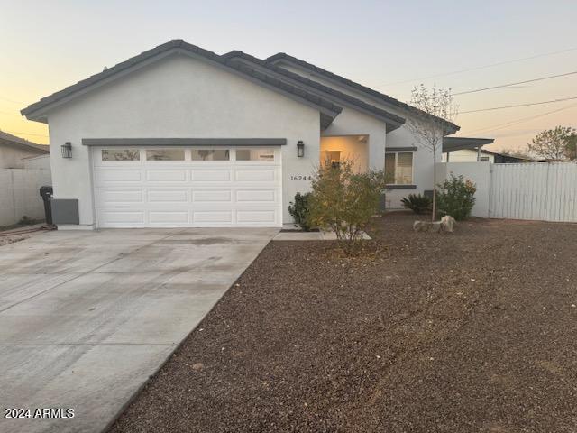 ranch-style home featuring a garage