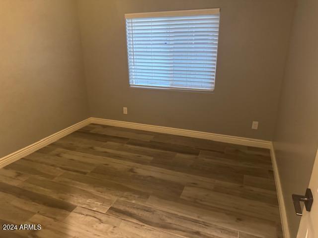 spare room with hardwood / wood-style floors