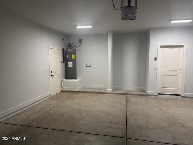 garage with electric water heater and a garage door opener