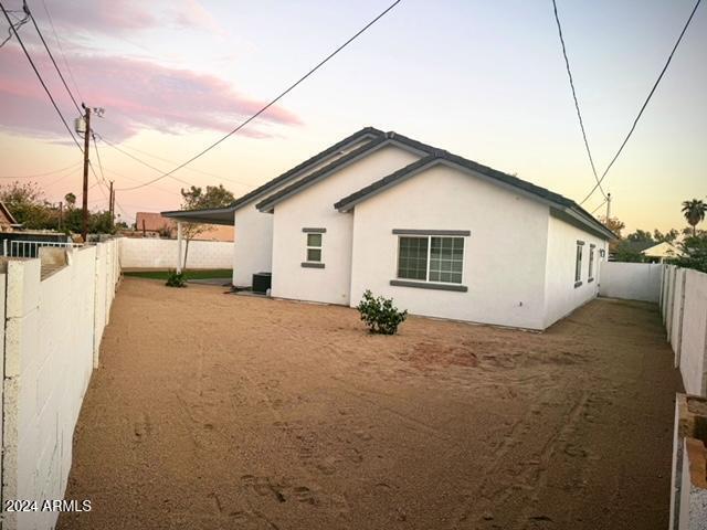 view of back house at dusk