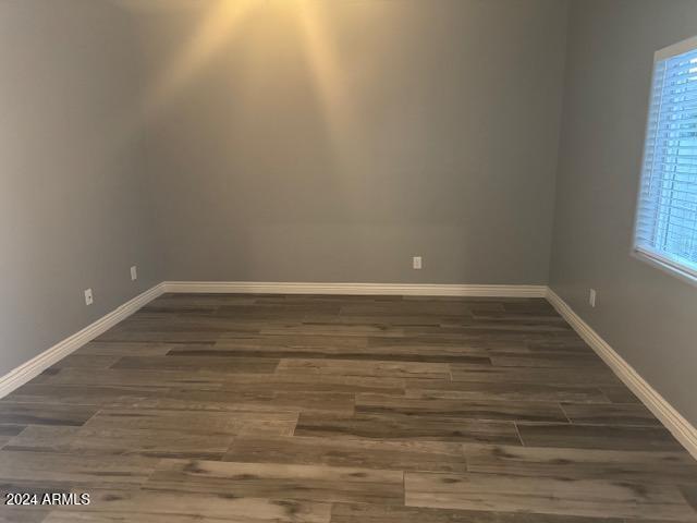 unfurnished room with dark hardwood / wood-style floors