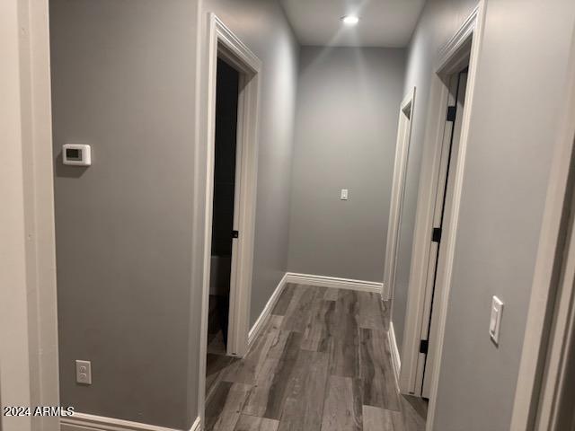 corridor featuring dark wood-type flooring