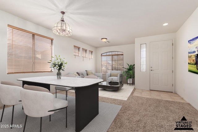 dining room featuring light carpet