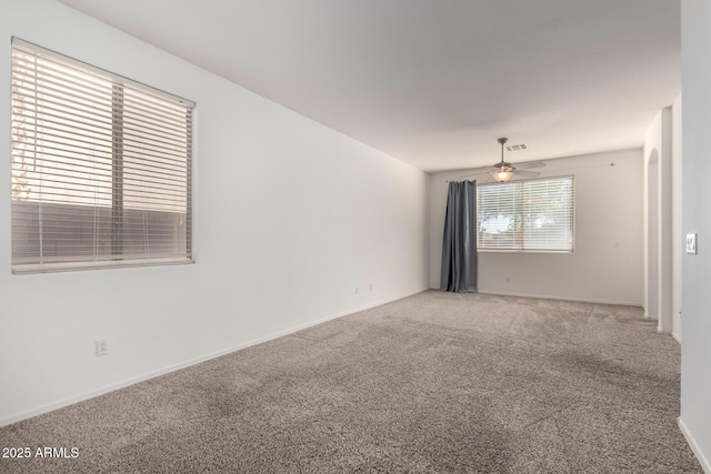 carpeted empty room featuring ceiling fan