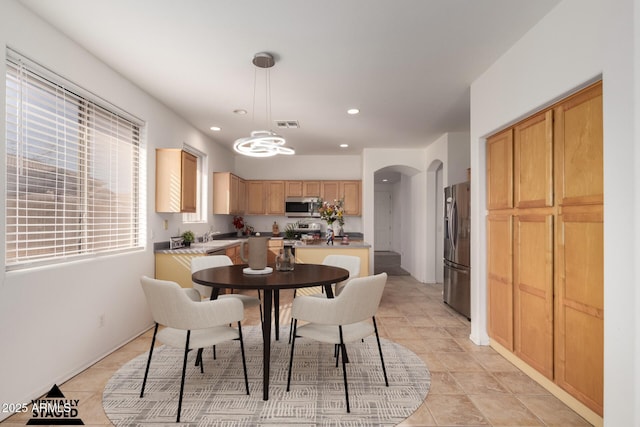 dining area featuring sink and light tile patterned floors