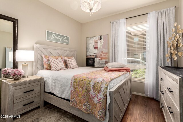 14250 W Wigwam Blvd Unit 812, Litchfield Park, AZ 85340 - bedroom with baseboards, an inviting chandelier, and dark wood-style floors