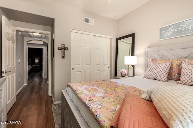 14250 W Wigwam Blvd Unit 812, Litchfield Park, AZ 85340 - bedroom with dark wood-type flooring, visible vents, a closet, and baseboards