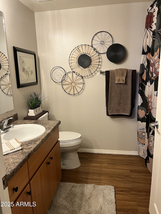 14250 W Wigwam Blvd Unit 812, Litchfield Park, AZ 85340 - bathroom with vanity, toilet, curtained shower, wood finished floors, and baseboards