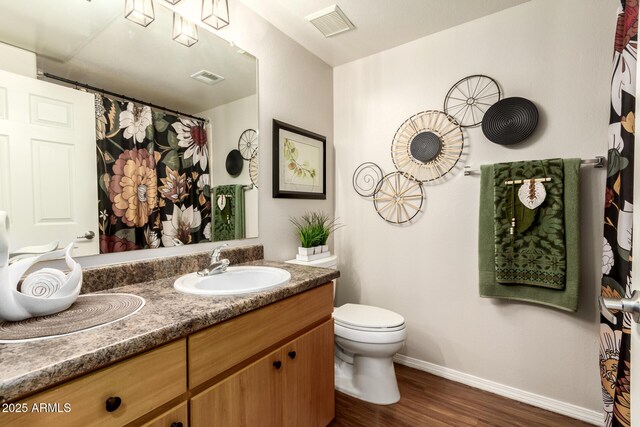 14250 W Wigwam Blvd Unit 812, Litchfield Park, AZ 85340 - full bath with visible vents, baseboards, vanity, and wood finished floors