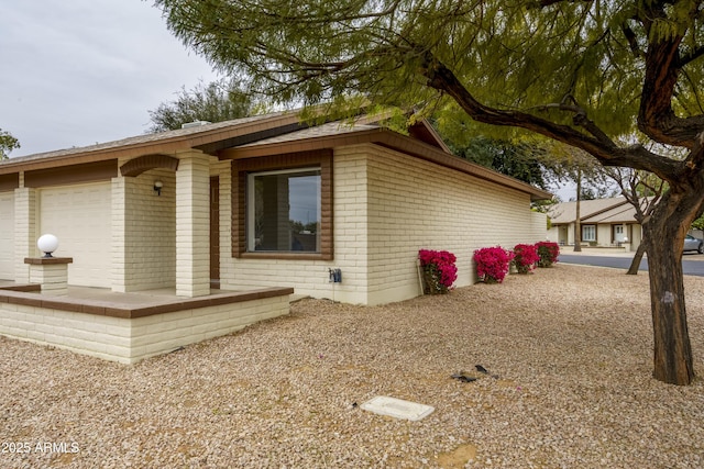 view of side of home with a garage