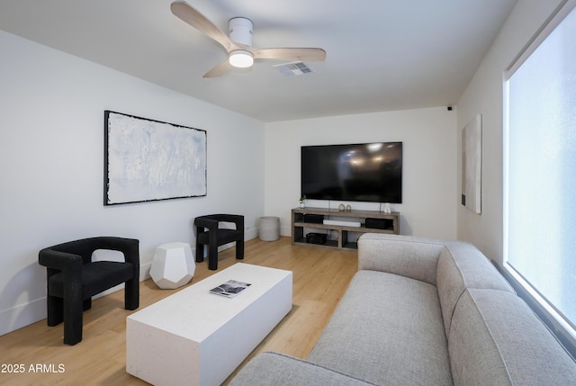 living room featuring ceiling fan and light hardwood / wood-style flooring