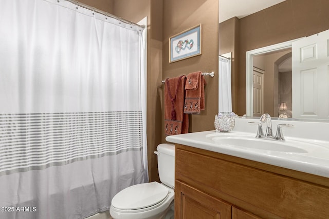 full bath featuring toilet, a shower with shower curtain, and vanity