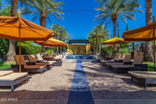 view of patio / terrace with outdoor lounge area, fence, and a community pool