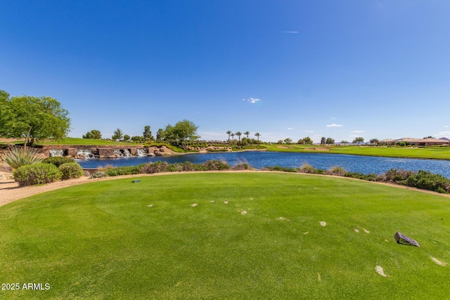 view of property's community featuring a yard and a water view