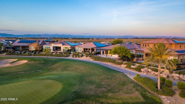 aerial view at dusk featuring a residential view