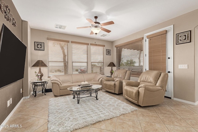 tiled living room with ceiling fan, visible vents, and baseboards