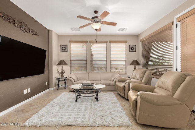 living room with a healthy amount of sunlight, ceiling fan, and visible vents