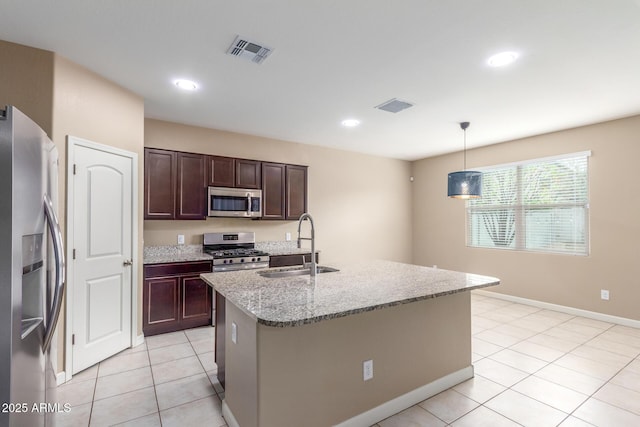 kitchen with light tile patterned floors, visible vents, appliances with stainless steel finishes, and a sink