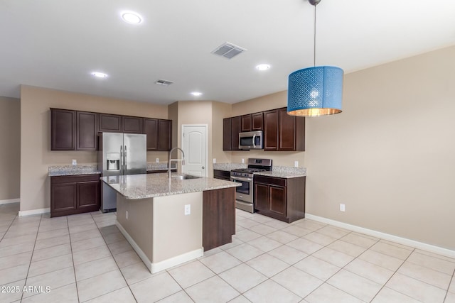 kitchen featuring appliances with stainless steel finishes, visible vents, a sink, and dark brown cabinetry