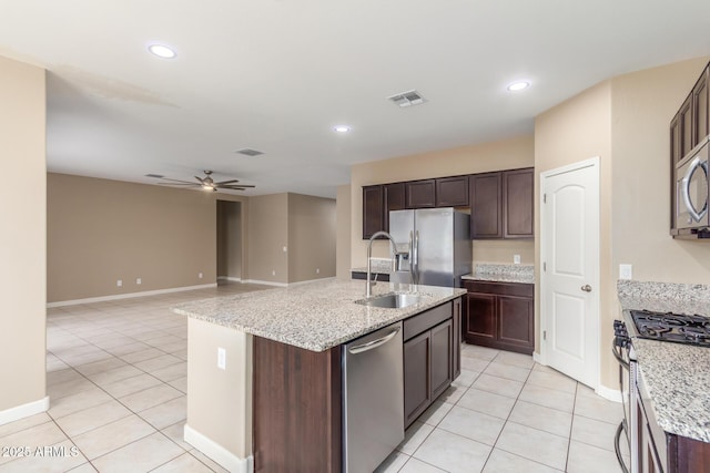 kitchen with appliances with stainless steel finishes, light tile patterned flooring, visible vents, and a ceiling fan