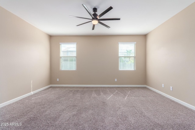 carpeted empty room with plenty of natural light, baseboards, and a ceiling fan