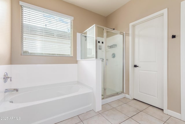 full bathroom with a stall shower, tile patterned flooring, and a garden tub