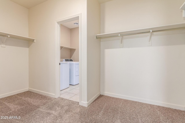 walk in closet with carpet and separate washer and dryer