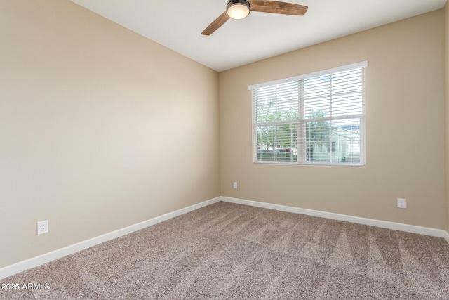 spare room featuring carpet, baseboards, and a ceiling fan