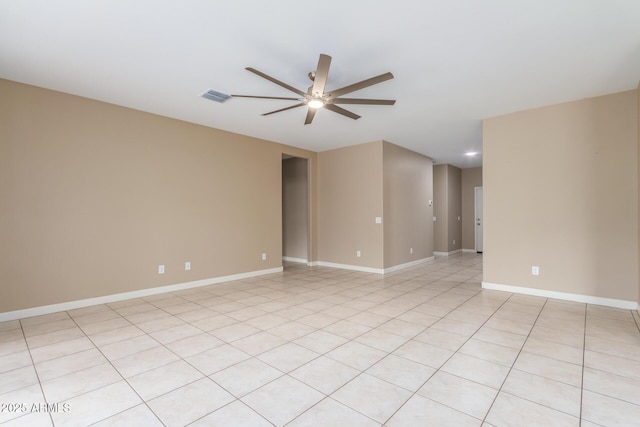 spare room with baseboards, visible vents, and a ceiling fan