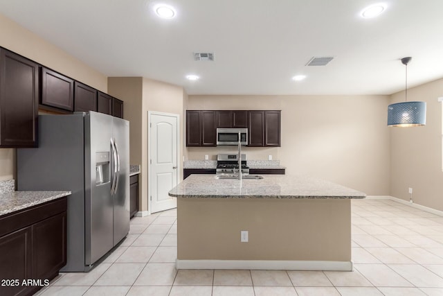 kitchen with dark brown cabinetry, visible vents, light tile patterned floors, and appliances with stainless steel finishes