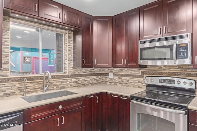 kitchen with sink, appliances with stainless steel finishes, and tasteful backsplash