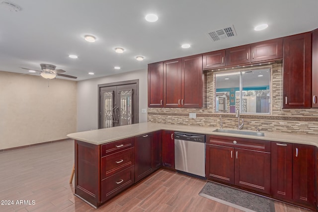 kitchen with sink, stainless steel dishwasher, ceiling fan, tasteful backsplash, and kitchen peninsula