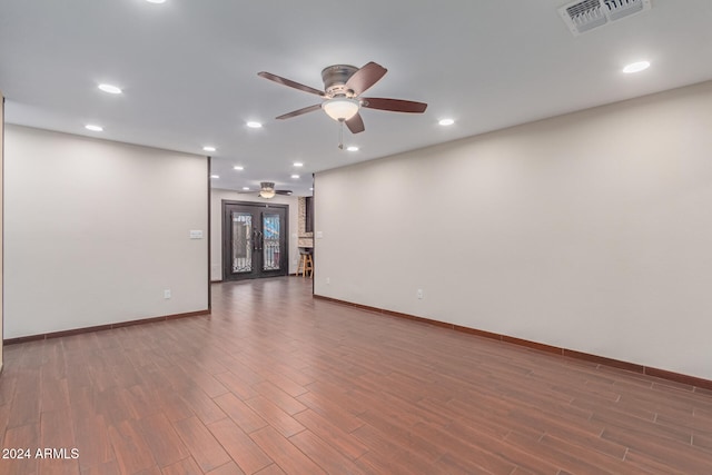 spare room with ceiling fan, dark hardwood / wood-style flooring, and french doors